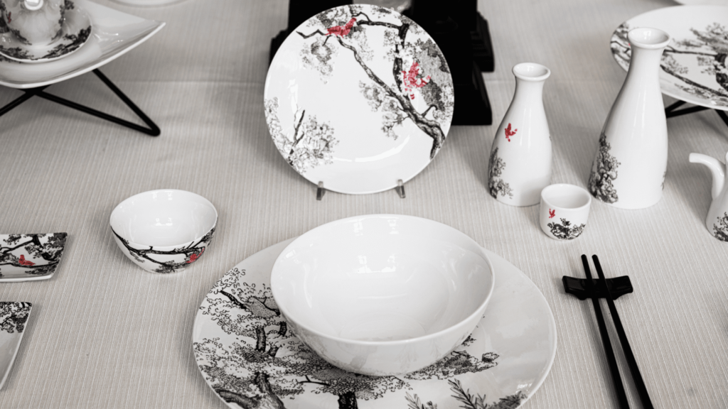 mise en place with oriental design ivory plates Le Coq Porcelaine