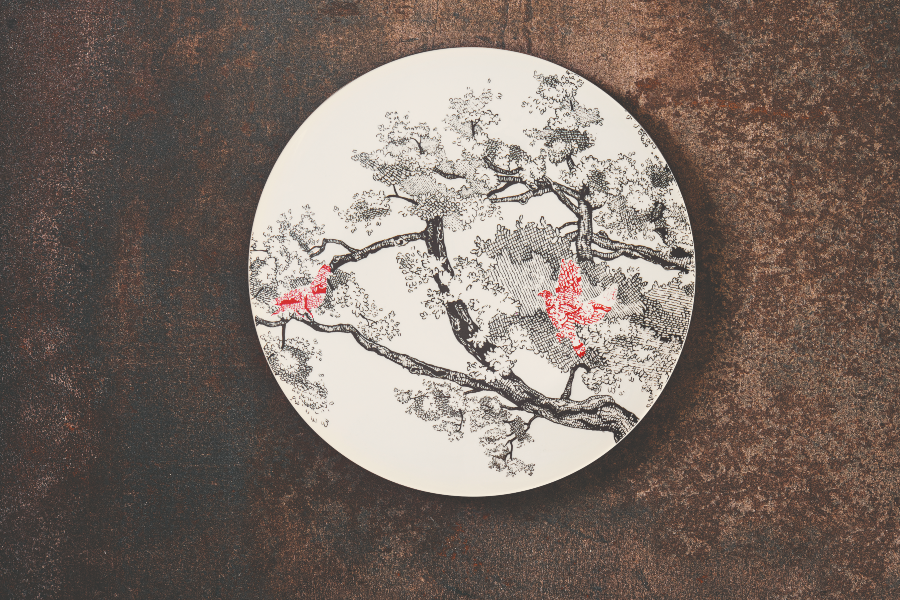 piatto avorio con decoro orientale collezione Kerasia by le Coq Porcelaine su sfondo ruggine